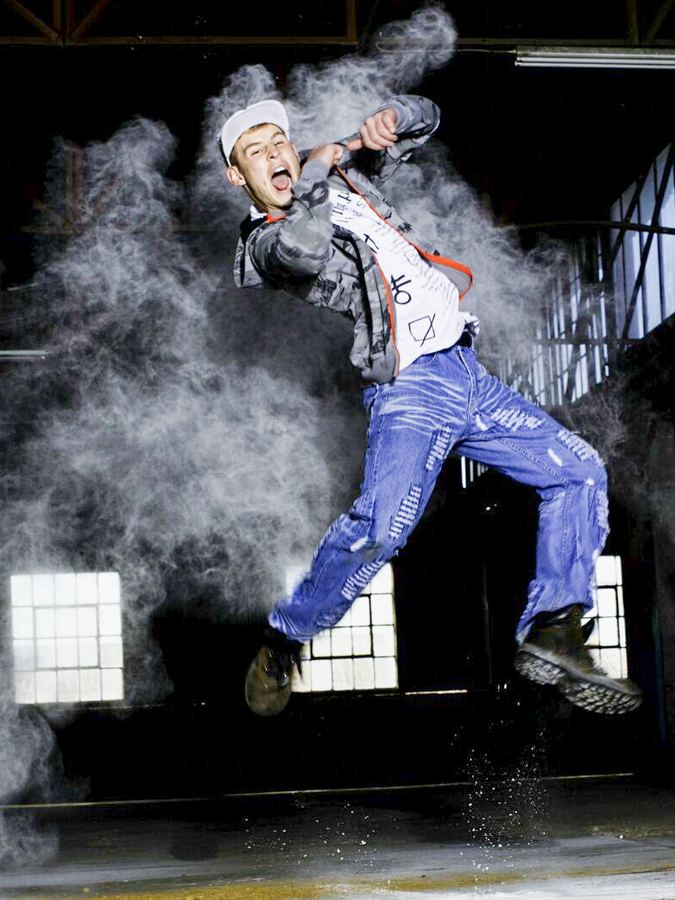Jason's son mid-jump in a cloud of flour during a hip-hop shoot