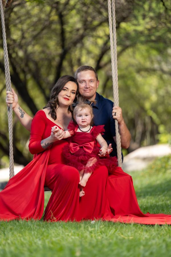 Family maternity shoot on a swing